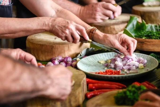 Preparing onions, chilli, and herbs for a Swahili meal
